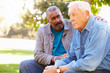 © Monkey Business - Man Comforting Unhappy Senior Friend Outdoors