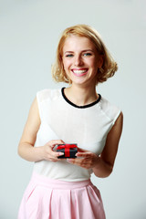 Poster - Smiling beautiful young woman holding jewelery gift box