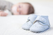 © David Pereiras - Baby blue shoes and babe sleeping on background