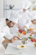© jackfrog - chef preparing a dish his team in the background