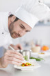 © jackfrog - closeup on chef garnishing a plate