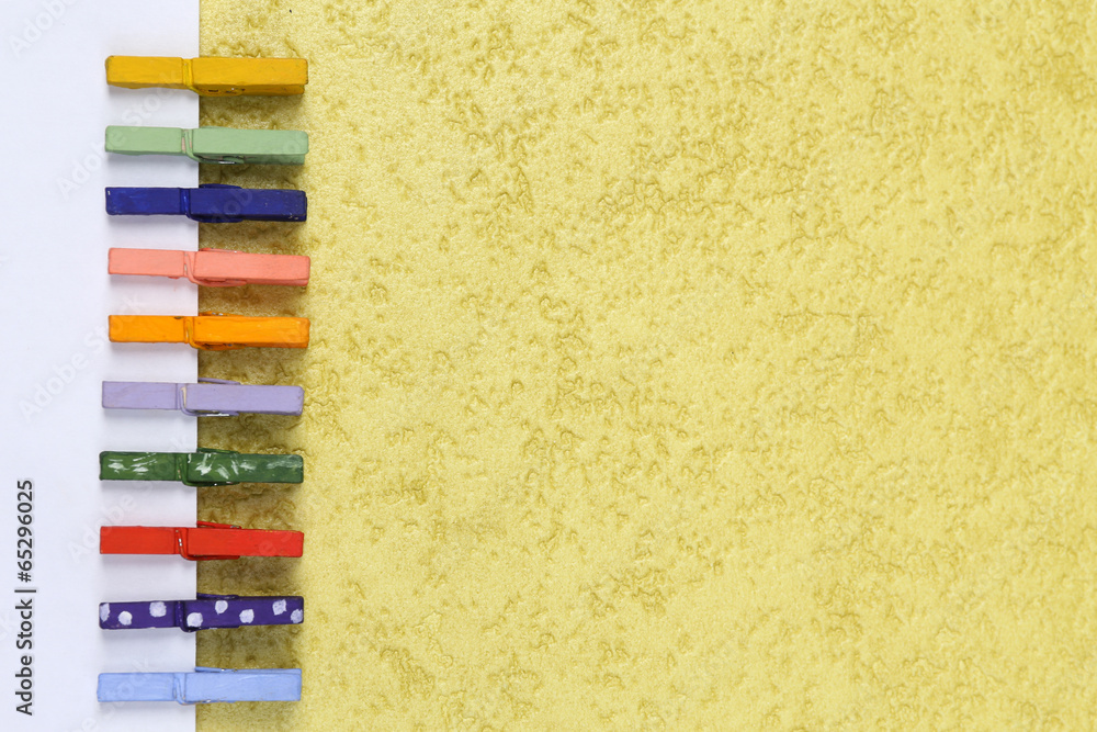 Abstract background with colorful wooden pins and paper