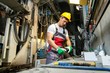 © Nejron Photo - Worker in safety hat in machinery room on a factory
