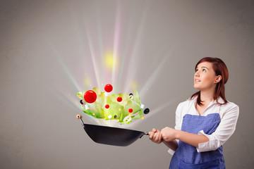 Wall Mural - Young woman cooking fresh vegetables