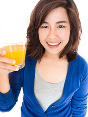 Isolated portrait of young happy woman drinking orange juice smi