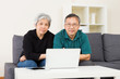 © leungchopan - Elder couple staying at home with laptop computer