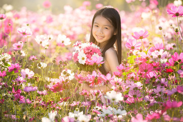 little asian girl in cosmos flower fields