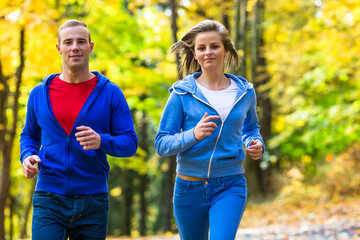 Wall Mural - Healthy lifestyle - woman and man running in park