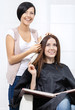 © Karramba Production - Beautician tries lock of dyed blond hair on the client