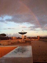Satellite Dish Under A Rainbow After Storm