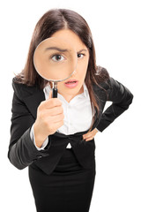 Wall Mural - Businesswoman looking through a magnifying glass