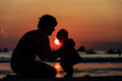 © nadezhda1906 - Silhouette of mother and daughter on sunset beach