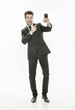 © jackfrog - handsome man in suit taking a selfie on isolated background