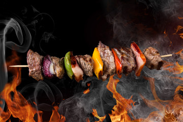 Wall Mural - Tasty skewers with fire flames.