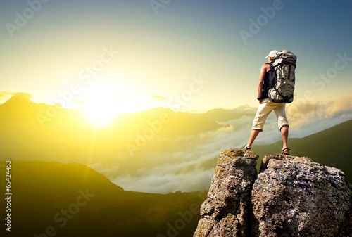 Fotografie, Obraz Tourist on rock. Sport and active life concept