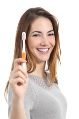 Wall Mural - Woman portrait with a perfect white smile holding a toothbrush