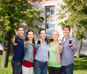 Canvas Print - students showing blank smartphones screens