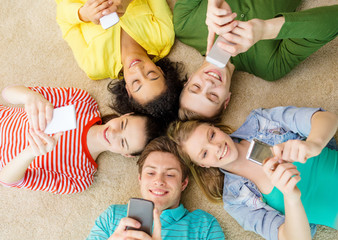 Poster - group of smiling people lying down on floor