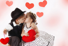 Girl And Boy Kissing And Holding Hearts