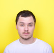 © irishmaster - Portrait of man with funny face against yellow background