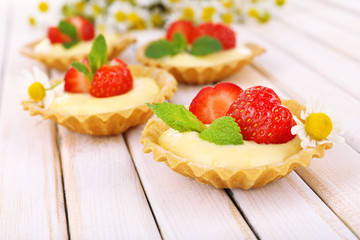 Sticker - Tasty tartlets with strawberries on table close-up