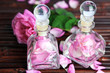 Rose oil in bottles on bamboo mat background