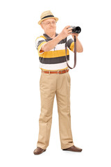 Canvas Print - Mature man taking a picture with camera