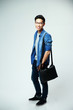 © Drobot Dean - Full length portrait of a young asian man with bag
