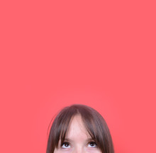 Portrait Of Beautiful Girl Looking Up Against Red Background