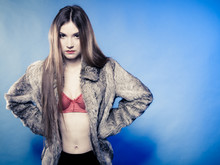Sexy Girl With Long Hair In Red Bra And Fur Coat On Blue