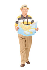 Poster - Mature tourist walking with map in his hands