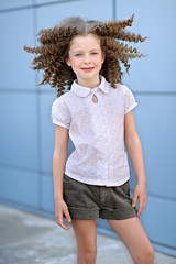 Wall Mural - portrait of little girl outdoors in summer