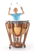Young Blond Boy Playing Kettle Drum