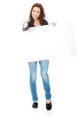 Portrait of happy woman with blank board