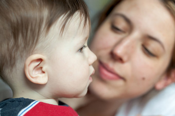 Close-up of a woman kissing her son