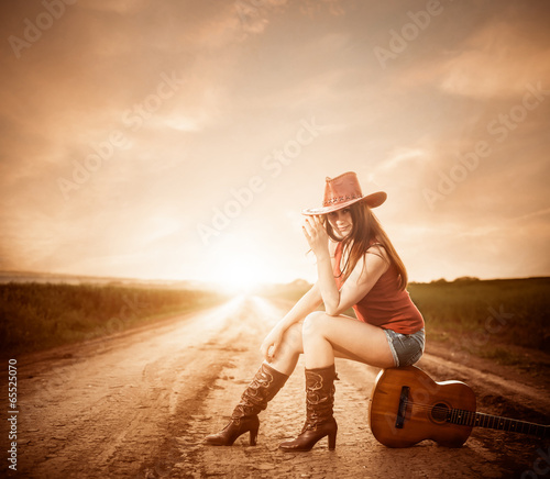 Dekoracja na wymiar  ladna-kobieta-w-czerwonym-kapeluszu-siedzi-na-gitarze-o-zachodzie-slonca-roa