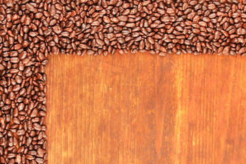 Wall Mural - Sunflower grains in chocolate, on brown  wooden background