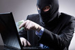 Dangerous businessman uses a laptop