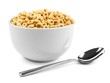 Bowl of oat cereal with spoon on white background