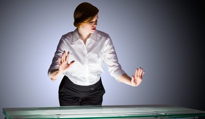 Poster - Redhead businesswoman standing and gesturing by a desk