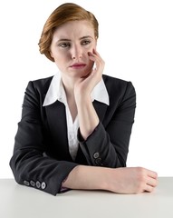 Poster - Thinking redhead businesswoman sitting at desk