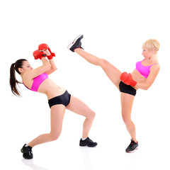 Wall Mural - sport training of two boxing young woman, studio over white