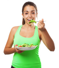 Wall Mural - young woman eating a fresh salad isolated on white background