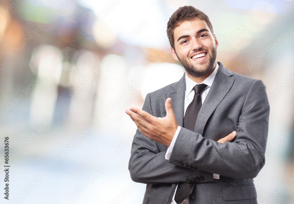 handsome young successful man doing a welcome gesture - obrazy, fototapety, plakaty 