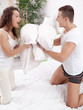 © V&P Photo Studio - Couple fighting together with pillows in bed