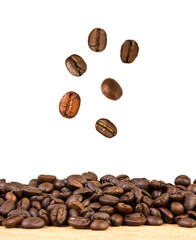 Wall Mural - roasted coffee beans is falling down on wood