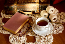 Cup Of Tea, Book And Glasses On Old Wooden Table.