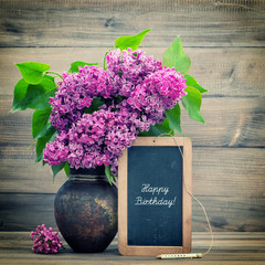 Wall Mural - bouquet of lilac flowers. blackboard with text Happy Birthday!