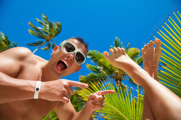 Wall Mural - Funny smiling man on the beach