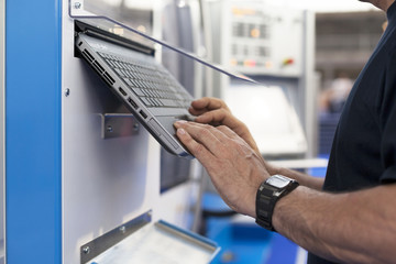 man working at a programmable machine